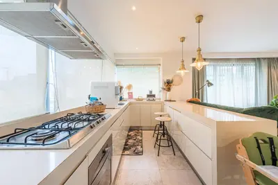 a kitchen with a stove top oven next to a counter at FAIRLANE 2mins walk to Bukit Bintang BEST SUNSET view 2BR 8-1 WIFI 100mbps in Kuala Lumpur