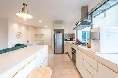 a kitchen with a refrigerator and a counter top at FAIRLANE 2mins walk to Bukit Bintang BEST SUNSET view 2BR 8-1 WIFI 100mbps in Kuala Lumpur