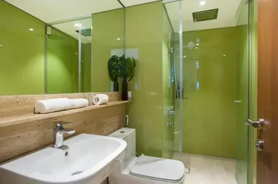 a bathroom with a toilet and a sink and a shower at GH KLCC Apartment by GuestHouse in Kuala Lumpur