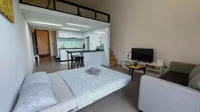 a living room with a bed and a couch at KL Sentral Loft , EST Bangsar #2, LRT in Kuala Lumpur