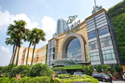 a large building with palm trees in front of it at KL Sentral Loft , EST Bangsar #2, LRT in Kuala Lumpur
