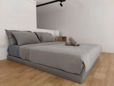 a large bed in a bedroom with a wooden floor at KL Sentral Loft, EST Bangsar #1, LRT in Kuala Lumpur
