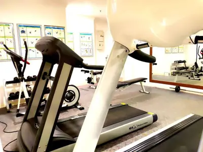 a gym with a treadmill and two exercise bikes at Eco One Bedroom Apartment @ Jalan Ampang, 3 pax in Kuala Lumpur