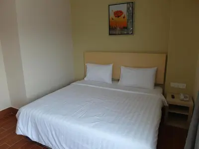 a bedroom with a bed with white sheets and pillows at Metro Hotel @ KL Sentral in Kuala Lumpur
