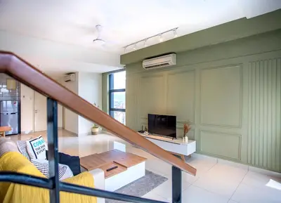 a living room with a couch and a tv at Near MITEC, Arte Mont Kiara by Cobnb in Kuala Lumpur