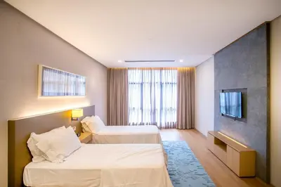 a hotel room with two beds and a tv at 188 Suites with Washer and Bathtub near KLCC Kula Lumpur in Kuala Lumpur