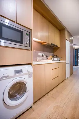 a kitchen with a washing machine and a microwave at 188 Suites with Washer and Bathtub near KLCC Kula Lumpur in Kuala Lumpur