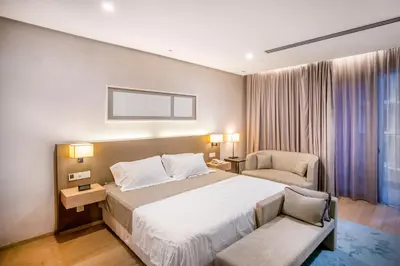 a hotel room with a bed and a chair at 188 Suites with Washer and Bathtub near KLCC Kula Lumpur in Kuala Lumpur