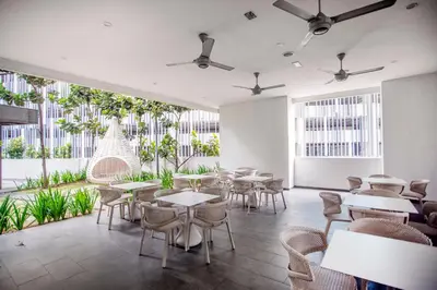 a restaurant with tables and chairs and plants at 188 Suites with Washer and Bathtub near KLCC Kula Lumpur in Kuala Lumpur