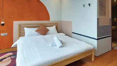 a bedroom with a white bed with a book on it at Private Room at Sky Suites KLCC by iRent365 in Kuala Lumpur