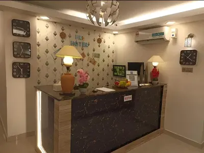 a reception desk in a hotel room with a lamp at FKI INTERNATIONAL HOTEL in Kuala Lumpur