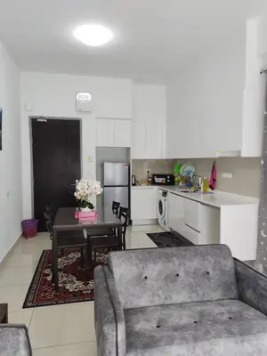 a living room with a couch and a table in a kitchen at ASTORIA AMPANG, 6Pax - Near KLCC, ZooNegara, AmpangPoint Mall in Kuala Lumpur