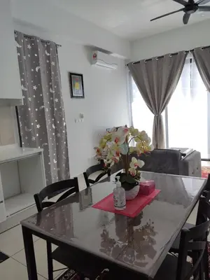 a dining room table with a vase of flowers on it at ASTORIA AMPANG, 6Pax - Near KLCC, ZooNegara, AmpangPoint Mall in Kuala Lumpur