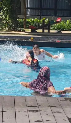 three children are swimming in a swimming pool at ASTORIA AMPANG, 6Pax - Near KLCC, ZooNegara, AmpangPoint Mall in Kuala Lumpur