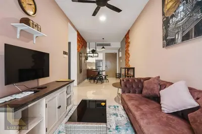 a living room with a couch and a flat screen tv at Legasi Kampung Baru Guesthouse in Kuala Lumpur