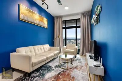 a living room with a white couch and a blue wall at Legasi Kampung Baru Guesthouse in Kuala Lumpur