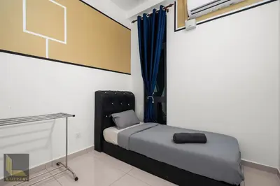 a small bedroom with a bed and a desk at Legasi Kampung Baru Guesthouse in Kuala Lumpur