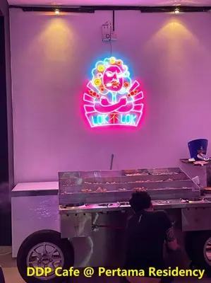 a neon sign on a wall next to a table at Private Jacuzzi Staycation at KL City 152 in Kuala Lumpur