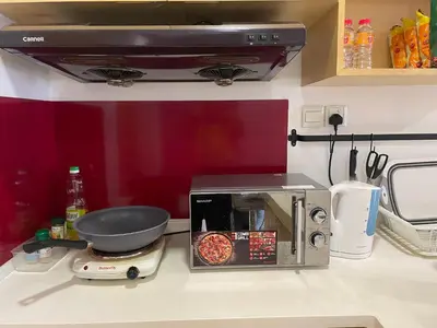 a kitchen counter with a toaster oven and a pan at Private Jacuzzi Staycation at KL City 1014 in Kuala Lumpur