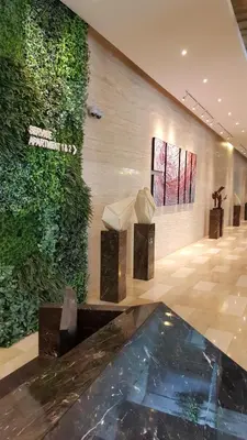 a lobby of a building with a green wall at MCity Jalan Ampang KLCC in Kuala Lumpur