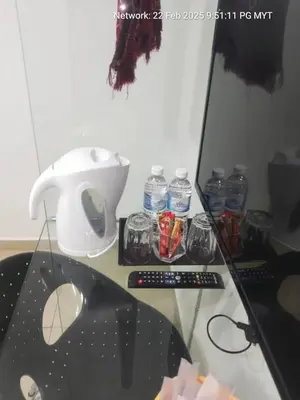 a glass table with a mixer and a remote control at ONE AMPANG HOTEL in Ampang