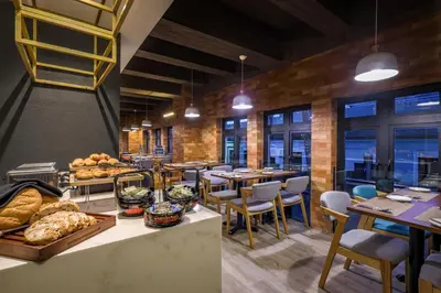 a restaurant with tables and chairs and a bakery at Santa Grand Classic Kuala Lumpur, Chinatown in Kuala Lumpur