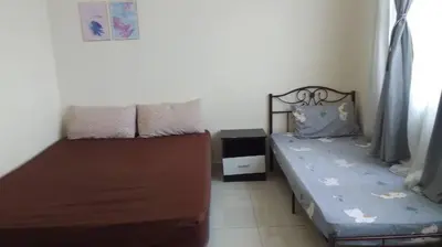 a small bedroom with two beds and a window at Vue Residence Servis Suite 3 pax Studio in Kuala Lumpur