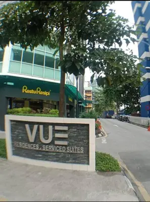 a sign on a sidewalk in front of a building at Vue Residence Servis Suite 3 pax Studio in Kuala Lumpur