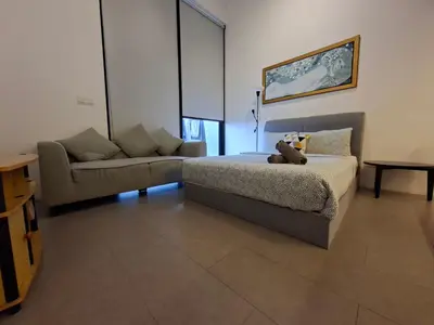a bedroom with a bed with a teddy bear on it at KL Sentral Loft, EST Bangsar #3, LRT in Kuala Lumpur