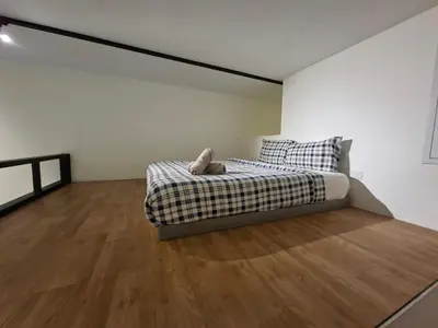 a bedroom with a bed and a wooden floor at KL Sentral Loft, EST Bangsar #3, LRT in Kuala Lumpur