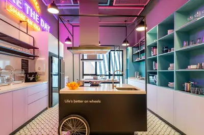 a kitchen with a food cart in the middle at lyf Chinatown Kuala Lumpur in Kuala Lumpur