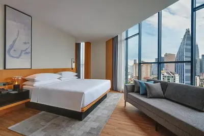a hotel room with a bed and a couch at Fairfield by Marriott Chow Kit Kuala Lumpur in Kuala Lumpur