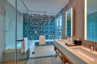 a bathroom with a tub and a sink and a mirror at Fairfield by Marriott Chow Kit Kuala Lumpur in Kuala Lumpur