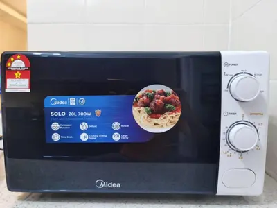 a microwave with a bowl of food on top of it at 3min MITEC KL Publika Ocean Classic Condo 2308 in Kuala Lumpur