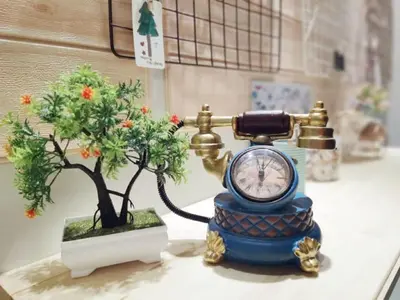 a clock and a bonsai tree sitting on a sink at 3min MITEC KL Publika Ocean Classic Condo 2308 in Kuala Lumpur