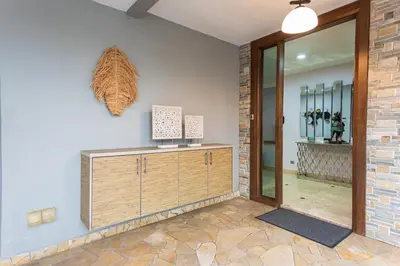a room with a wooden dresser and a mirror at 25P Enchanting Bungalow Retreat - Mystical Garden,Petaling Jaya by Verano in Petaling Jaya