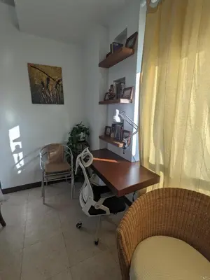 a office with a desk and a chair and a table at Damansara Suites in Kuala Lumpur