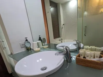 a bathroom with a sink and a mirror at Damansara Suites in Kuala Lumpur