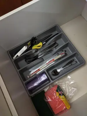 a drawer with scissors and other utensils in it at Damansara Suites in Kuala Lumpur