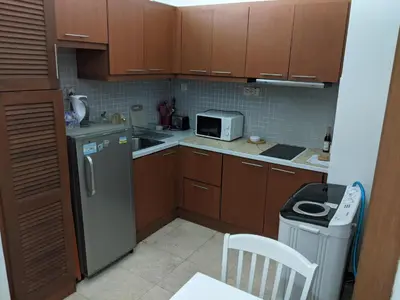 a small kitchen with a refrigerator and a microwave at Damansara Suites in Kuala Lumpur