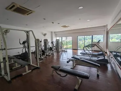 a gym with several tread machines in a room at Damansara Suites in Kuala Lumpur