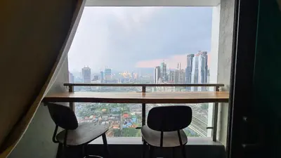a room with a table and two chairs in front of a window at Rumah Kampong Bharu near KLCC (3Rooms) in Kuala Lumpur