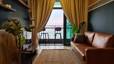 a living room with a couch and a large window at Rumah Kampong Bharu near KLCC (3Rooms) in Kuala Lumpur