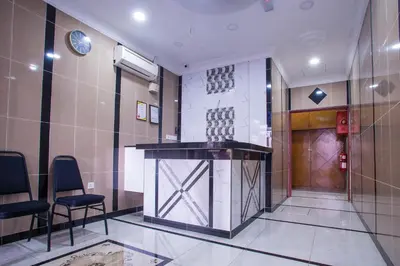 a lobby with a bar in the middle of a building at MK Inn Hotel in Kuala Lumpur
