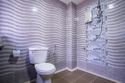 a bathroom with a toilet and a shower at MK Inn Hotel in Kuala Lumpur
