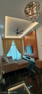a living room with a couch and a chandelier at Legasi Kampung Baru apartment by Rumahrehat twin tower view in Kuala Lumpur