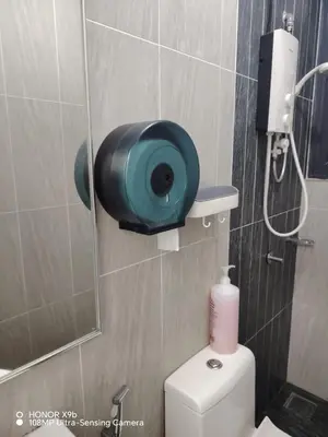 a bathroom with a toilet with a mirror and a shower at Legasi Kampung Baru apartment by Rumahrehat twin tower view in Kuala Lumpur
