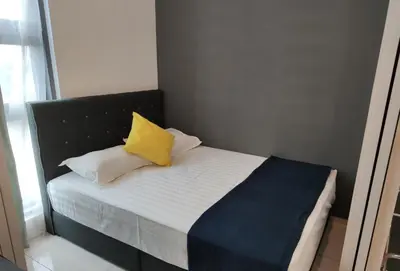 a bed with two yellow pillows on it in a room at MyCribKL The Robertson 2 Bedroom Bukit Bintang in Kuala Lumpur