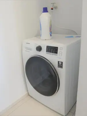 a white washing machine with a bottle on top of it at MyCribKL The Robertson 2 Bedroom Bukit Bintang in Kuala Lumpur