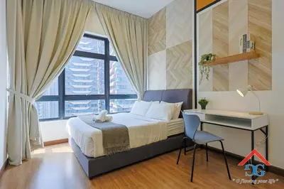 a bedroom with a bed and a desk and a window at Astoria Ampang in Kuala Lumpur